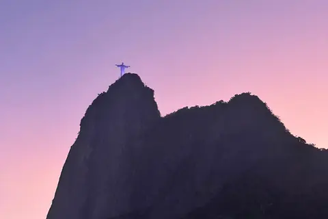 Corcovado against a pink dusk sky, seen from Botafogo
